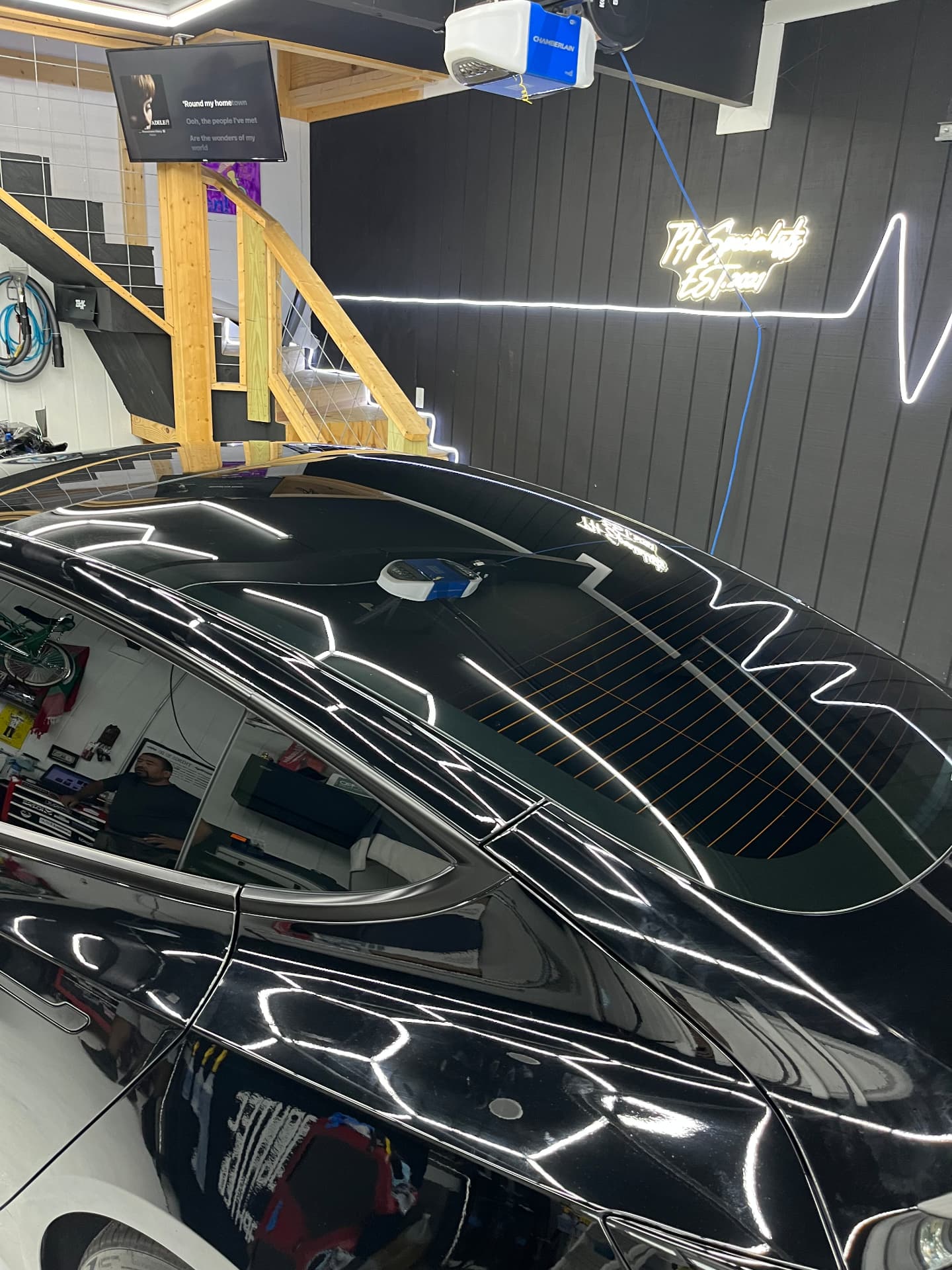 Rear windshield ceramic tint and paint gloss detail on a Tesla